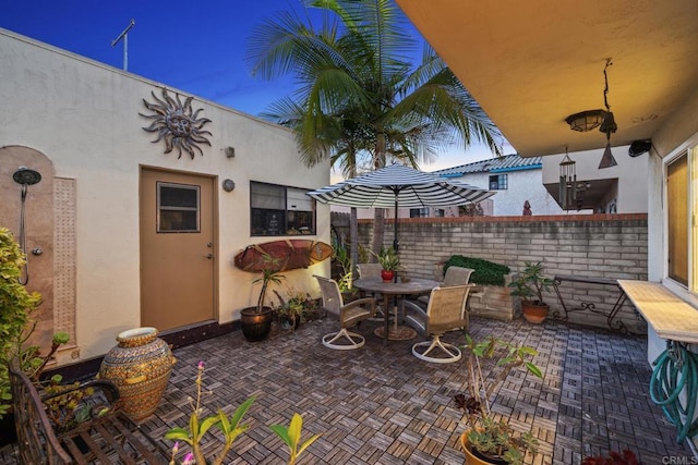 view of patio featuring fence and outdoor dining area