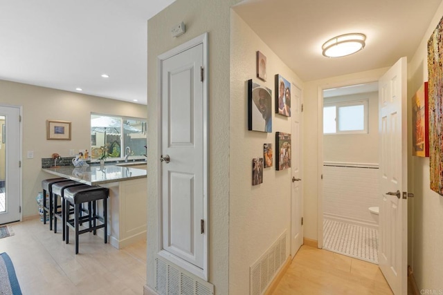 hallway featuring recessed lighting and visible vents