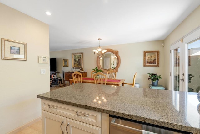 kitchen with hanging light fixtures, stone counters, a chandelier, and dishwasher