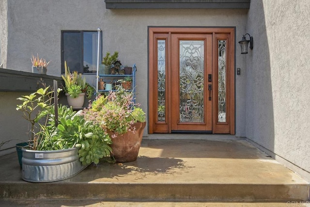 property entrance featuring stucco siding