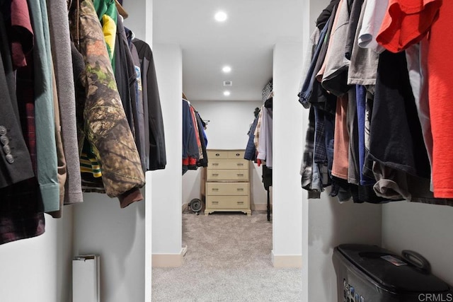 walk in closet with carpet floors