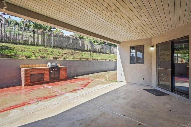 view of patio with fence and area for grilling