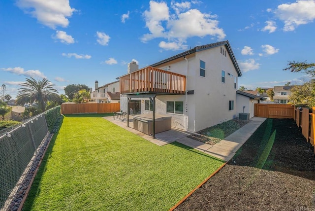 back of property featuring stucco siding, a hot tub, central AC, a patio area, and a fenced backyard