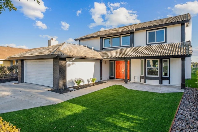 view of front of house featuring an attached garage, a tile roof, driveway, a chimney, and a front yard