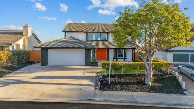 traditional home featuring a garage, driveway, brick siding, and a tile roof