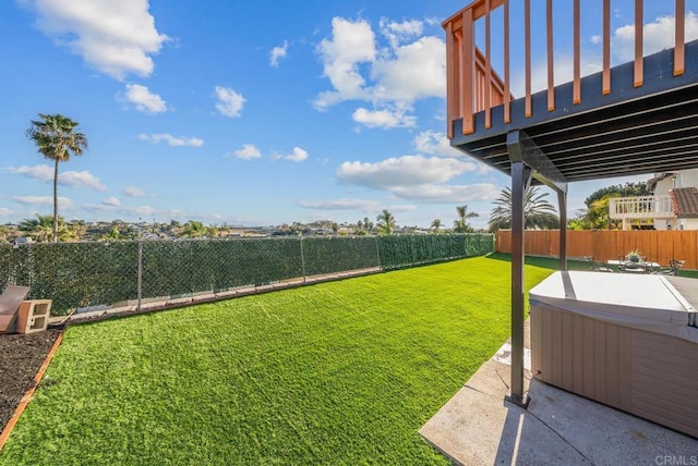 view of yard featuring a hot tub and a fenced backyard