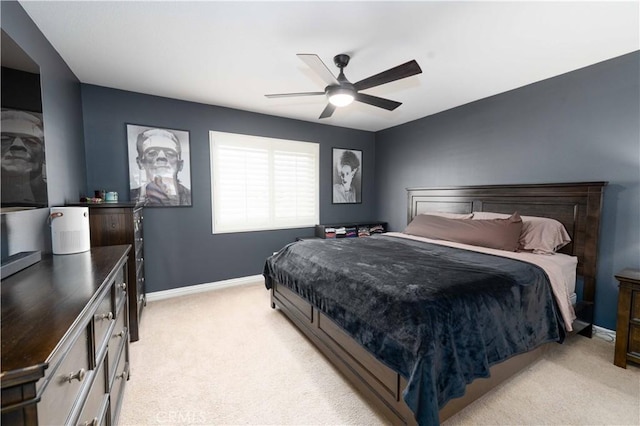 bedroom featuring a ceiling fan, light carpet, and baseboards