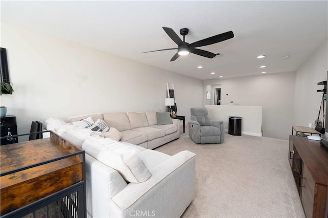 living room featuring light carpet, a ceiling fan, and recessed lighting