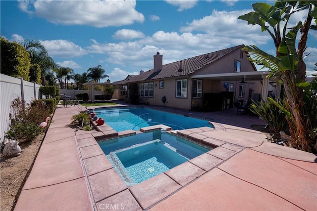 view of swimming pool with a patio area, a fenced backyard, and a pool with connected hot tub