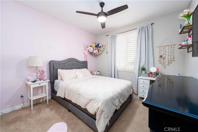 bedroom with light carpet, a ceiling fan, and baseboards