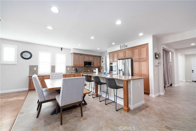 dining room with light tile patterned floors, recessed lighting, and baseboards