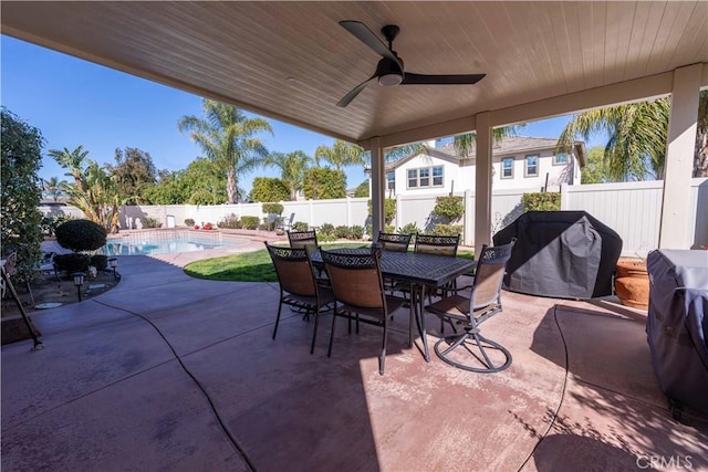 view of patio / terrace featuring a ceiling fan, area for grilling, a fenced in pool, a fenced backyard, and outdoor dining space