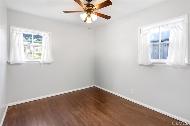 unfurnished room featuring ceiling fan, baseboards, and wood finished floors