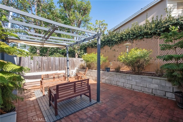 view of patio / terrace featuring outdoor lounge area, fence, and a pergola