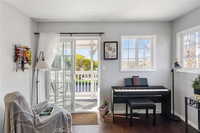 sitting room featuring baseboards and dark wood-style flooring