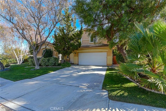 obstructed view of property featuring stucco siding, a garage, driveway, a tiled roof, and a front lawn