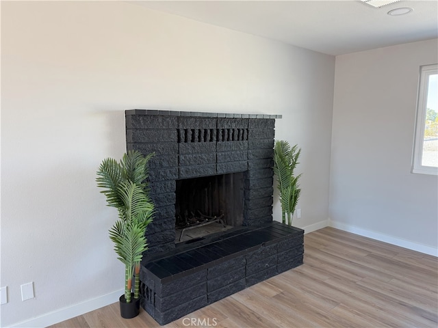 420 N Yorktown St, Ridgecrest, CA 93555 - details featuring a brick fireplace, baseboards, and wood finished floors