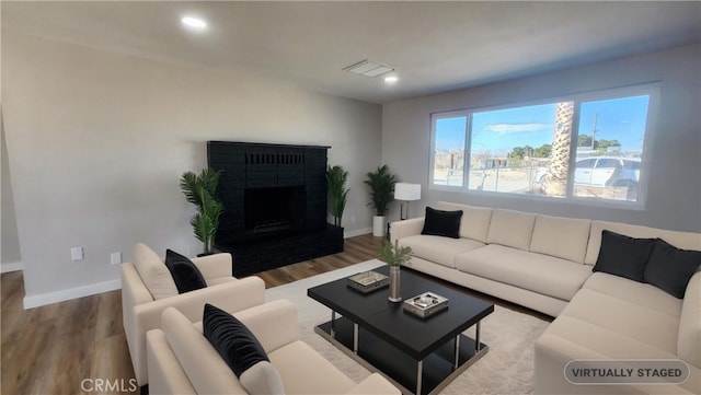 420 N Yorktown St, Ridgecrest, CA 93555 - living room featuring a brick fireplace, baseboards, and wood finished floors
