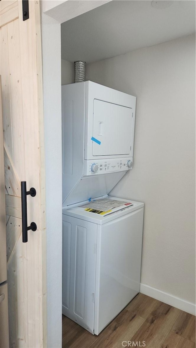 420 N Yorktown St, Ridgecrest, CA 93555 - laundry area featuring laundry area, stacked washer / dryer, wood finished floors, and baseboards