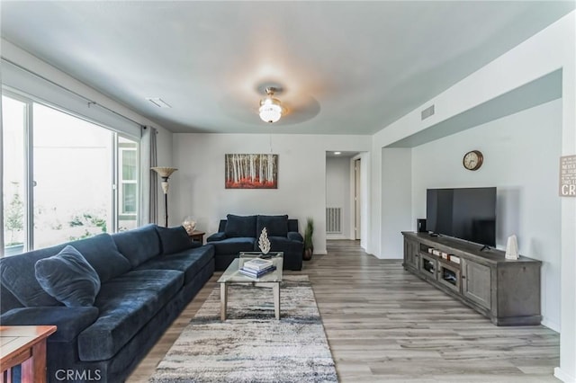 living area featuring visible vents and light wood-style flooring