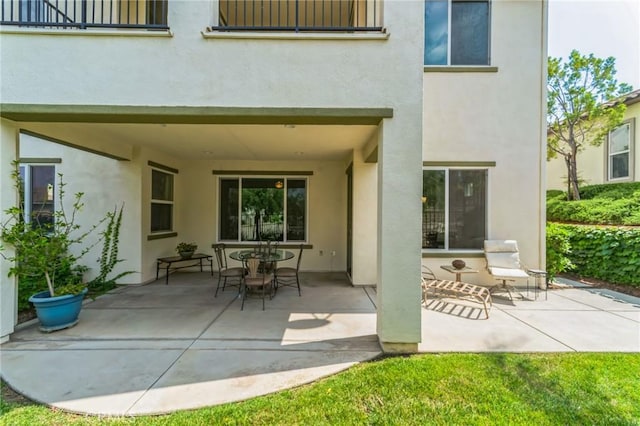 back of house featuring a patio and stucco siding