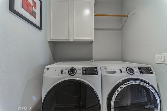 laundry area with cabinet space and washing machine and dryer