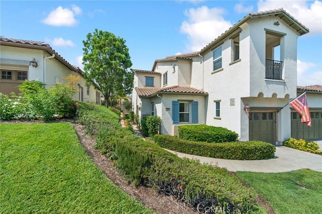 mediterranean / spanish house featuring driveway, a garage, a balcony, a tiled roof, and stucco siding