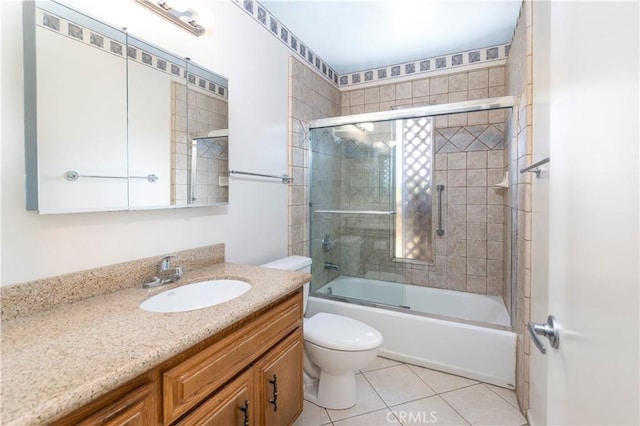 bathroom featuring shower / bath combination with glass door, vanity, toilet, and tile patterned floors