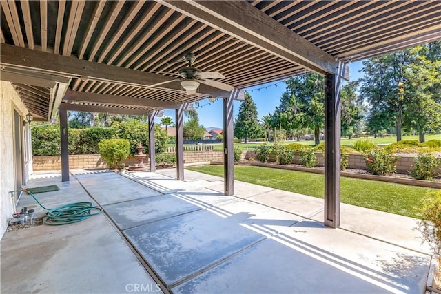 view of patio with ceiling fan, fence, and a pergola