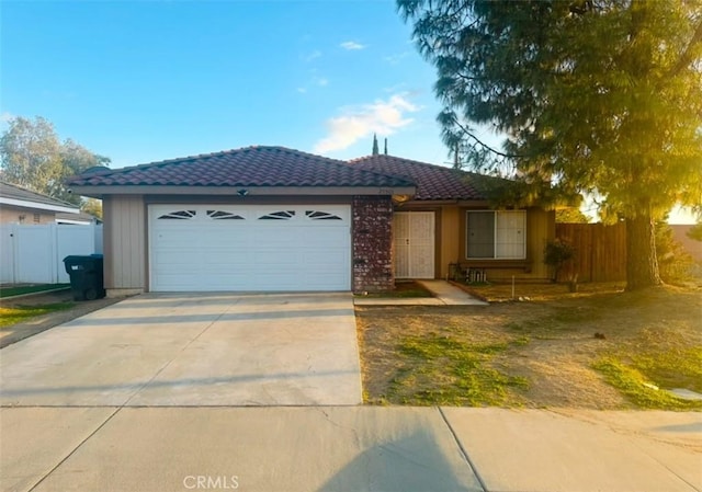 ranch-style house with a garage, driveway, fence, and a tiled roof