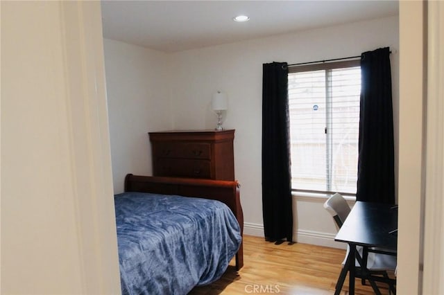 bedroom featuring multiple windows, recessed lighting, wood finished floors, and baseboards