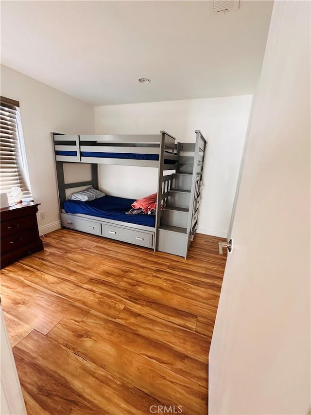 25501 Sand Creek Trl, Moreno Valley, CA 92557 - bedroom with baseboards and wood finished floors