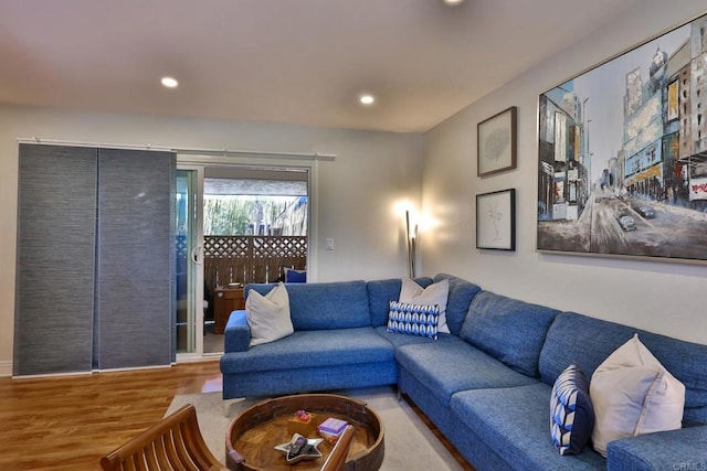 living area featuring wood finished floors and recessed lighting