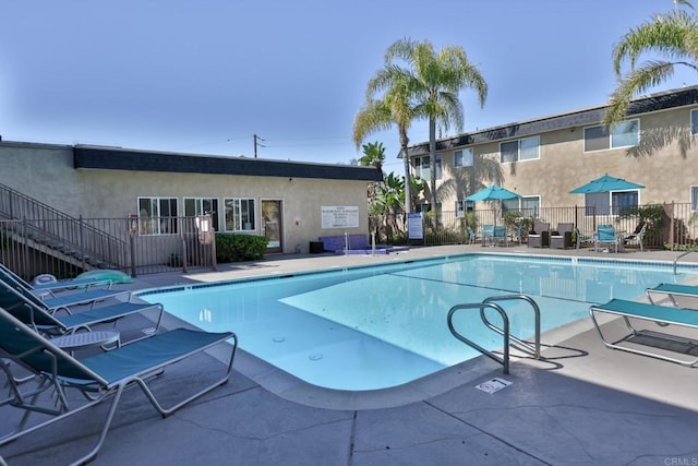 pool featuring a patio area and fence