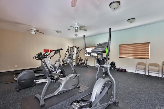 gym with baseboards and a ceiling fan