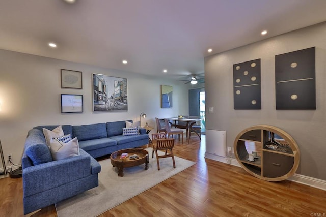 living area featuring recessed lighting, baseboards, and wood finished floors