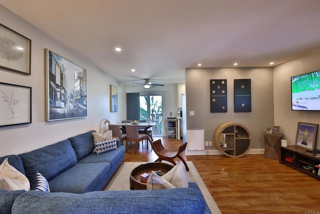 living room featuring light wood-style floors, recessed lighting, ceiling fan, and baseboards