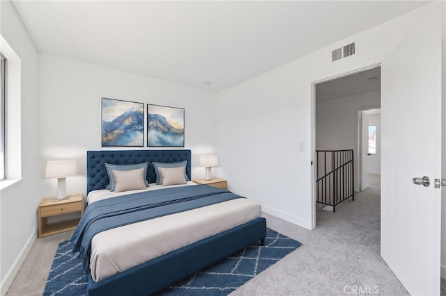 bedroom featuring carpet flooring, visible vents, and baseboards