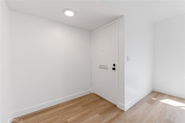 interior space featuring light wood finished floors and baseboards