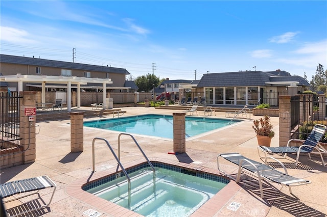 pool featuring a patio, a community hot tub, and fence