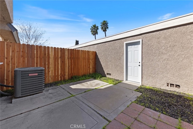 view of patio / terrace featuring central AC unit and fence