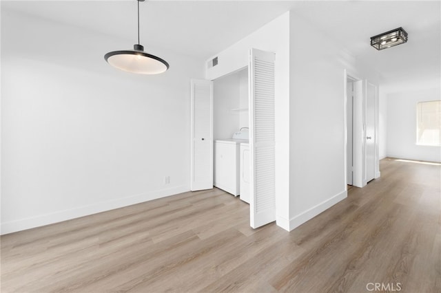 interior space featuring visible vents, baseboards, and wood finished floors