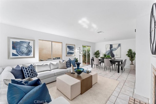 living room with visible vents and light tile patterned floors