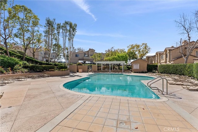 pool featuring a patio area and a residential view