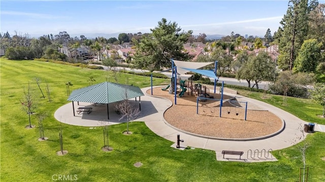 view of home's community with playground community and a yard