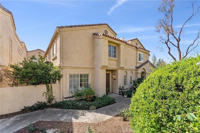 mediterranean / spanish-style house with a tile roof and stucco siding