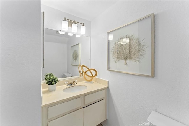 bathroom featuring vanity and toilet