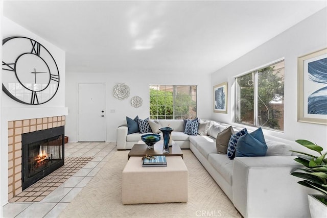 living room with a tile fireplace and tile patterned flooring