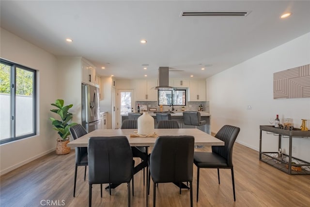 dining area featuring light wood-style flooring, visible vents, baseboards, and recessed lighting