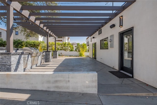 view of patio / terrace featuring a pergola, grilling area, and exterior kitchen